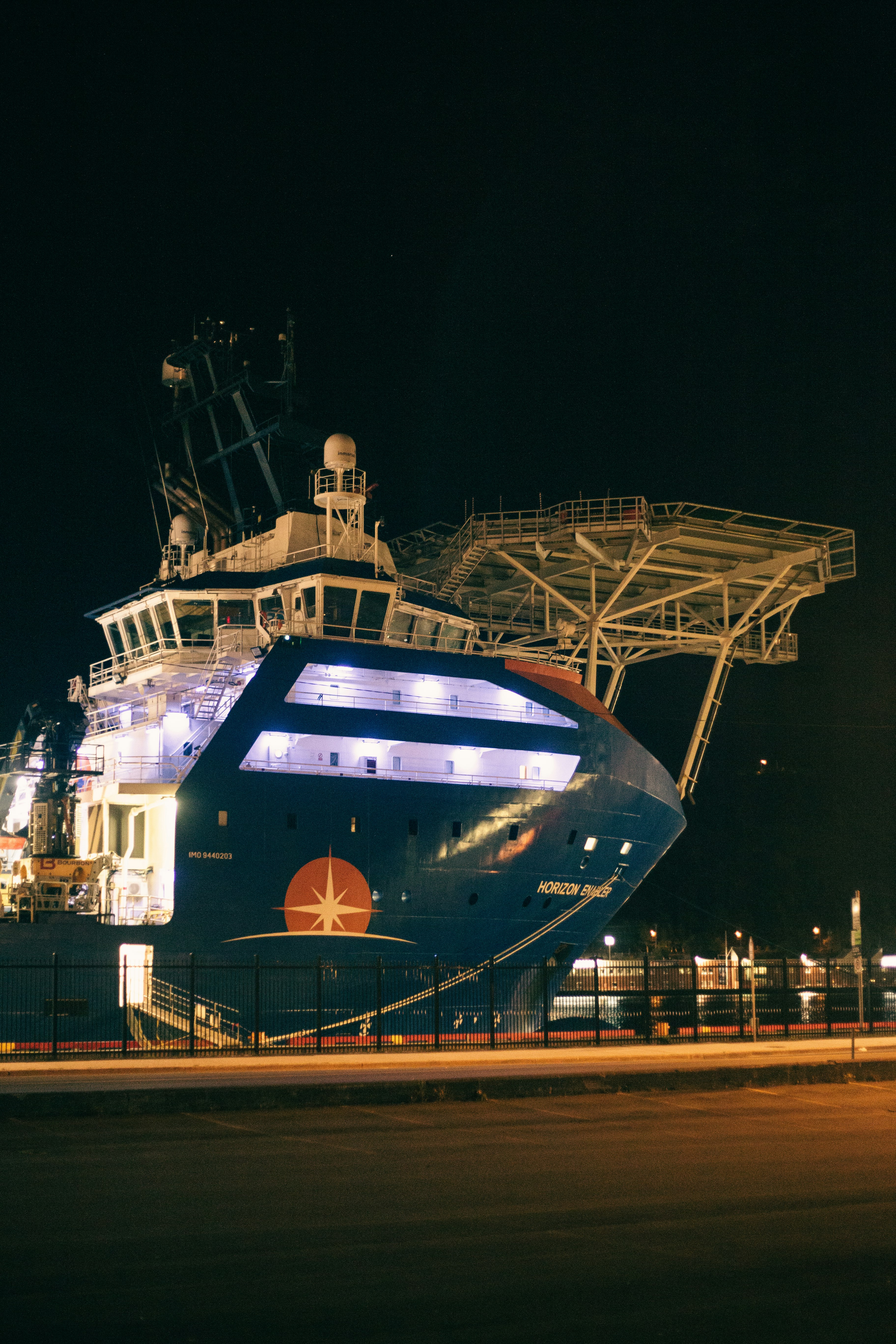 blue and white ship on dock during night time